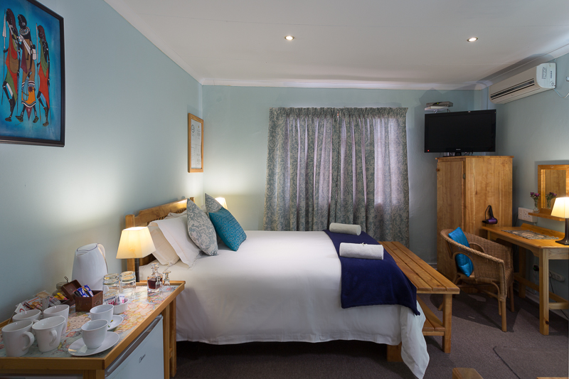 Room 6 has a double bed and two singles, with an en-suite bathroom with shower